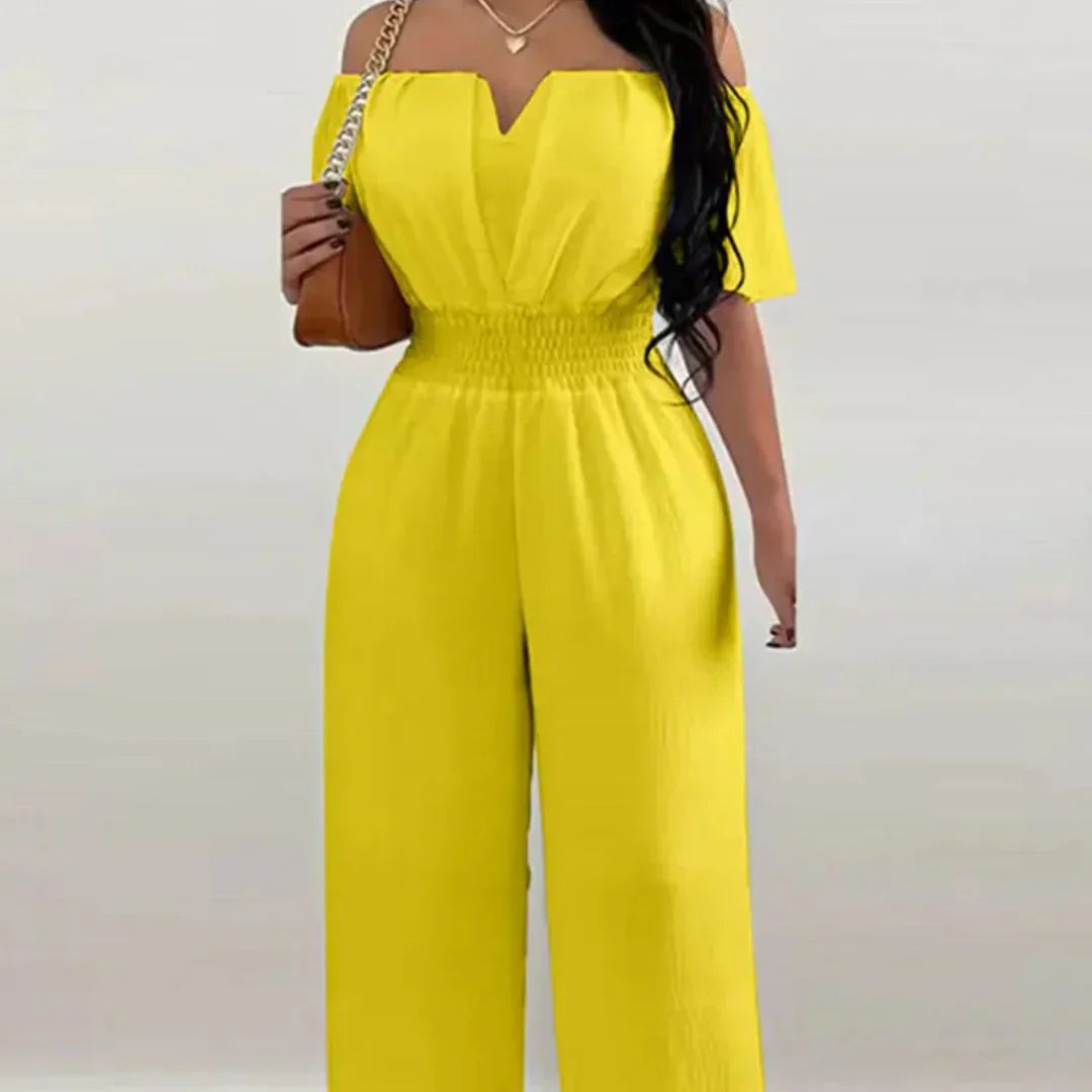 Back view of the solid pink off-shoulder jumpsuit, highlighting its relaxed and flattering silhouette.