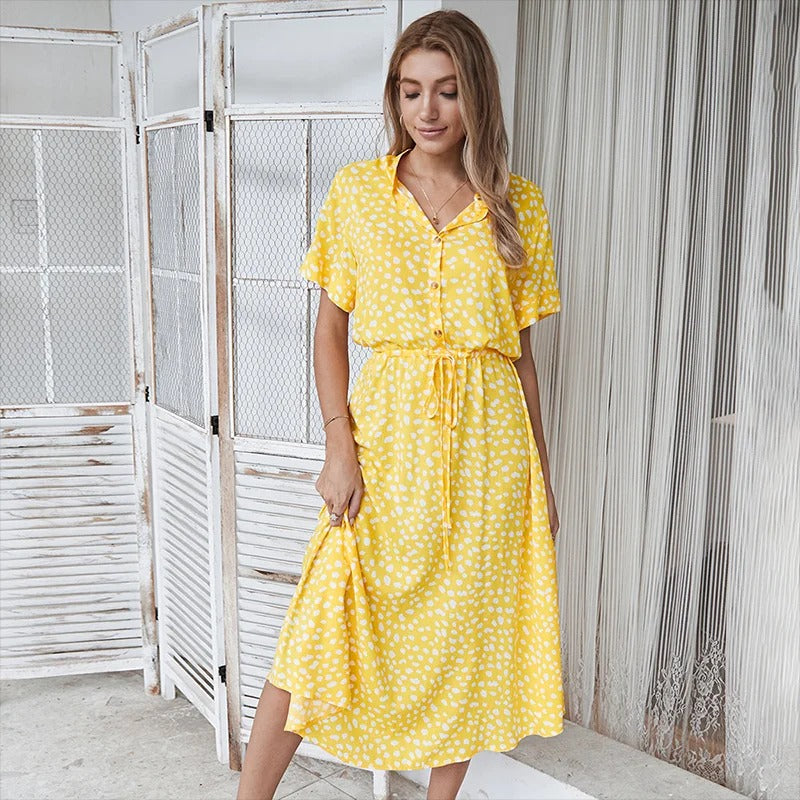 Lifestyle shot of a woman happily walking in the printed midi dress, enjoying a sunny day.