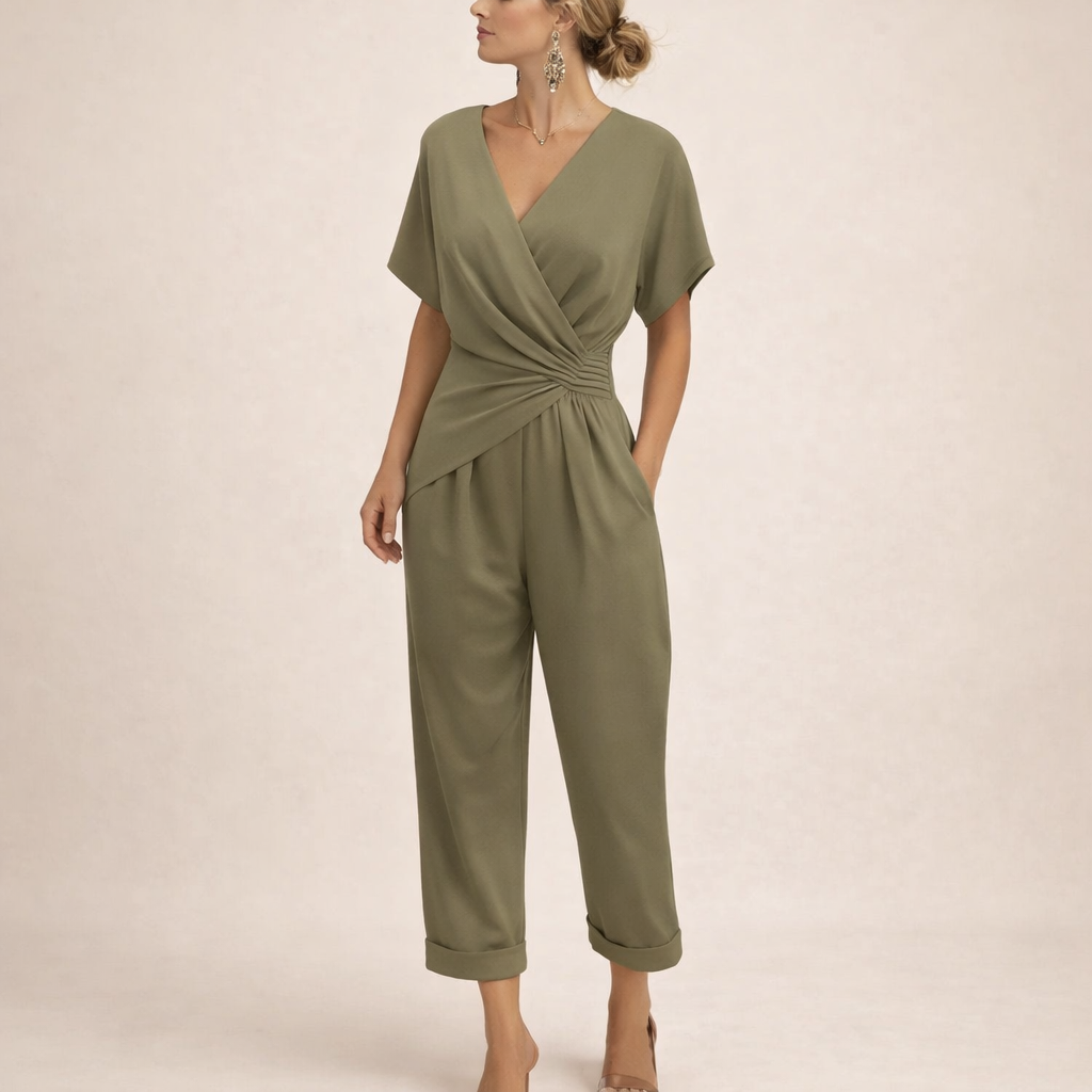 Side profile of a woman in a blue chic wrap jumpsuit, highlighting the loose sleeves and overall relaxed fit.
