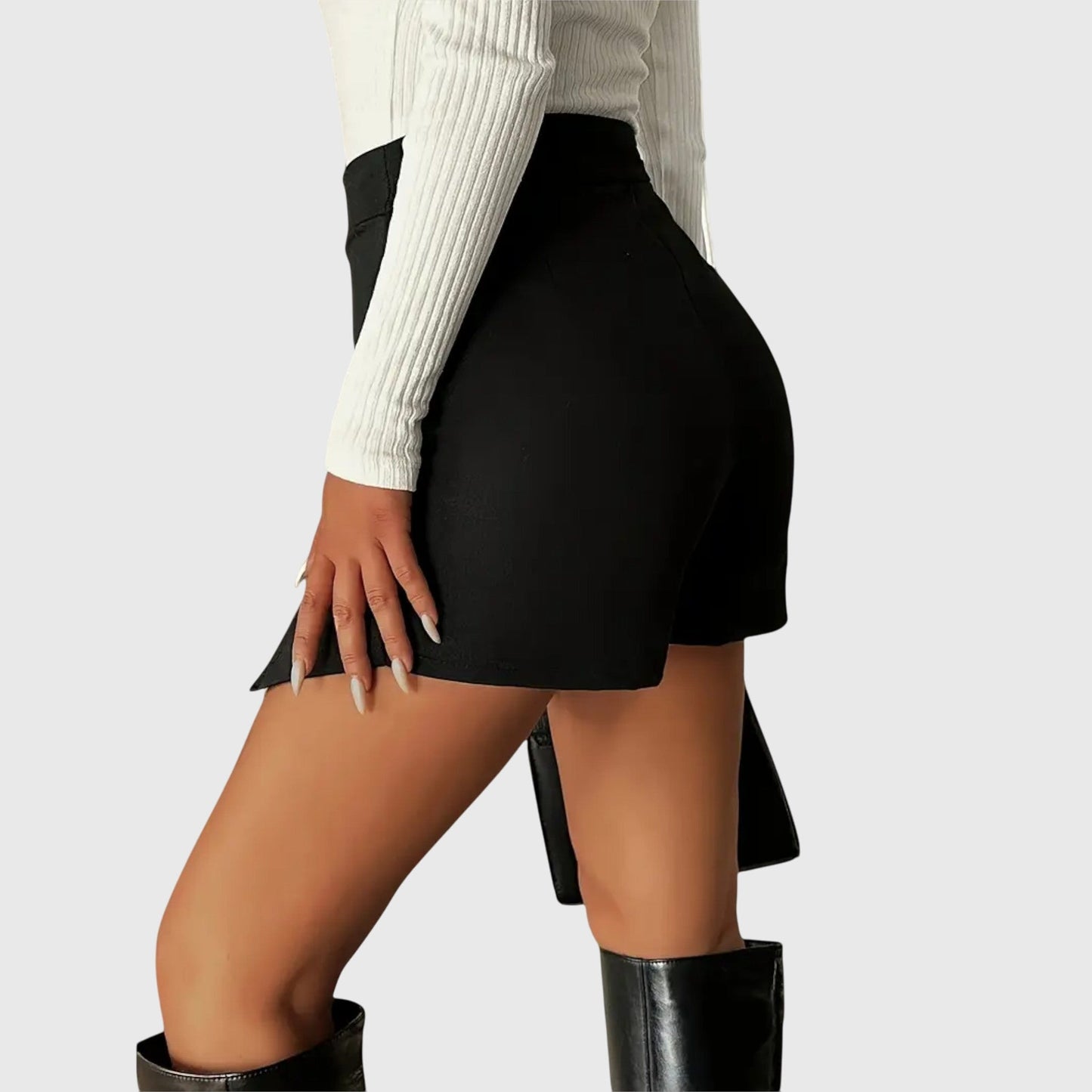 Lifestyle shot of a woman wearing the black Luna structured mini skirt, paired with a blouse, walking confidently outdoors.