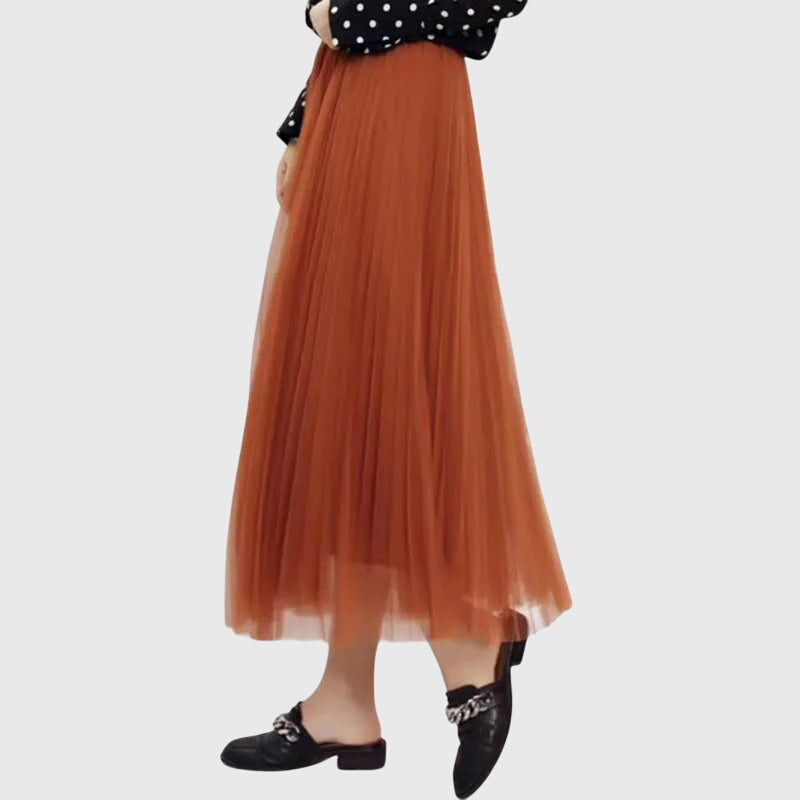 Back view of the Seraphina flowy pleated midi skirt in a classic beige, showing the comfortable waistband and full, airy silhouette.