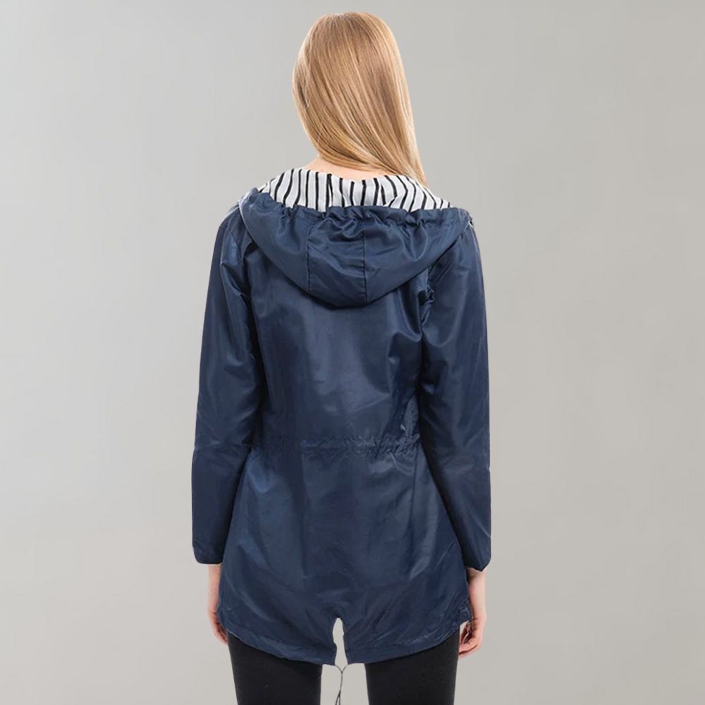 A vibrant yellow fashionable waterproof jacket laid flat, showcasing its smooth waterproof textile.