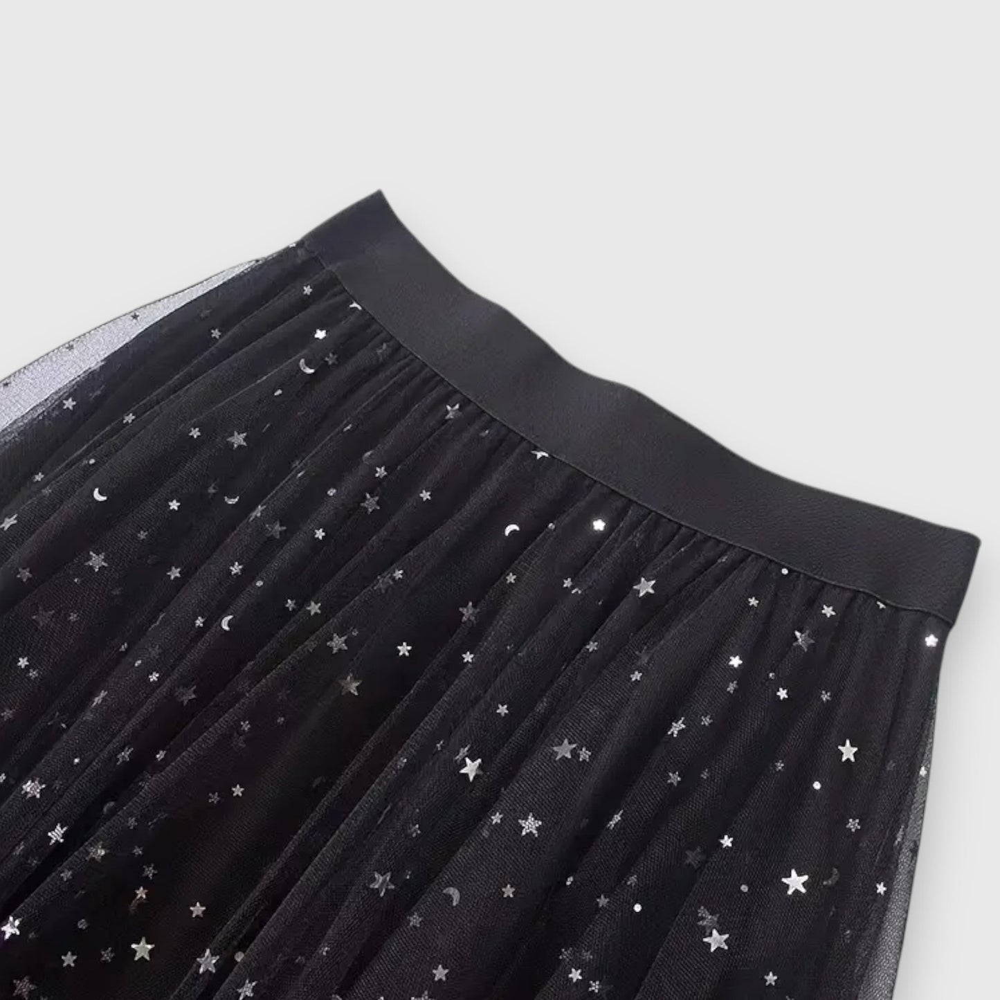 A stack of the elegant Valentina shimmering tulle midi skirts in various colors, displaying their soft texture.