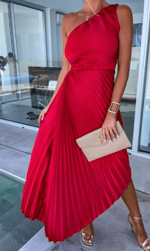 Side profile of the white Ainsley one-shoulder pleated midi dress, highlighting the asymmetric hem and flowing pleats.