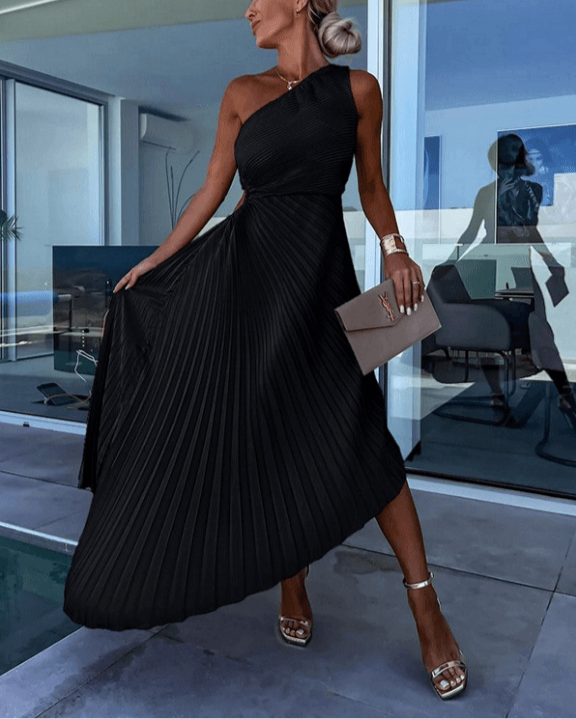 Back view of a model wearing the red Ainsley one-shoulder pleated midi dress, showing the drape of the fabric.