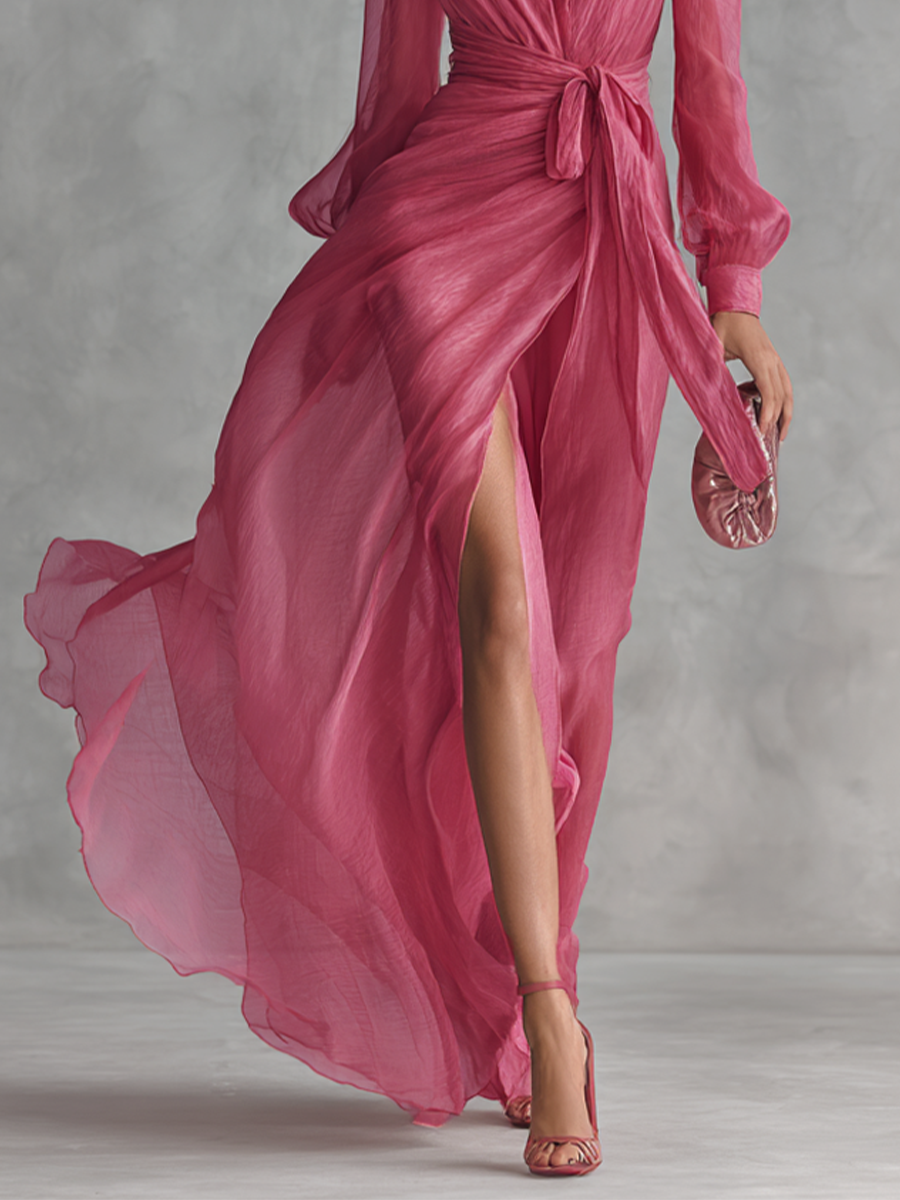 Back view of the elegant V-neck dress, illustrating the graceful movement of the long skirt with its subtle slit.