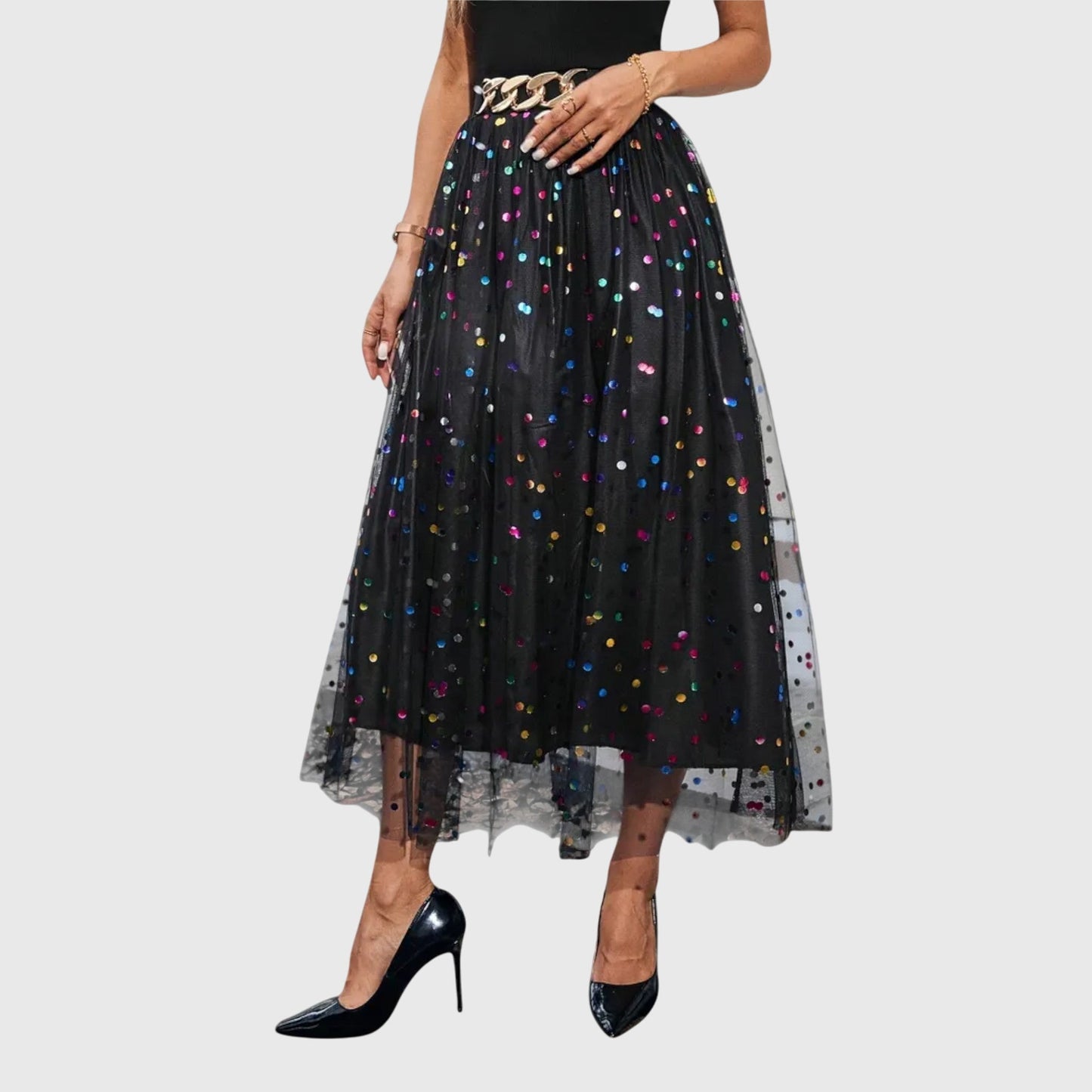Close-up detail of the sparkling tulle midi skirt's fabric, highlighting its delicate texture and subtle shimmer.