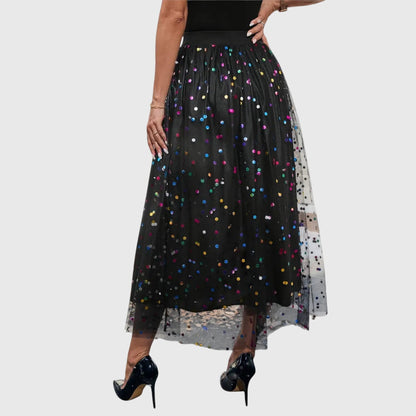 Side profile of a model wearing the black sparkling tulle midi skirt, emphasizing its graceful movement and comfortable fit.