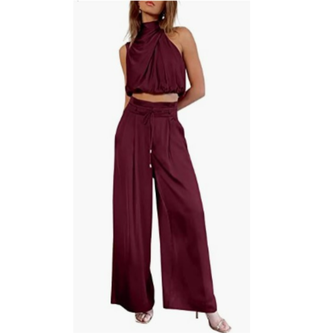 Side profile of a woman wearing a vibrant red Seraphina jumpsuit, highlighting the flowy fabric and elegant silhouette.