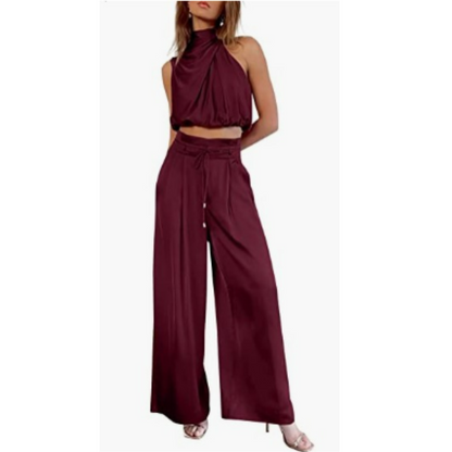 Side profile of a woman wearing a vibrant red Seraphina jumpsuit, highlighting the flowy fabric and elegant silhouette.