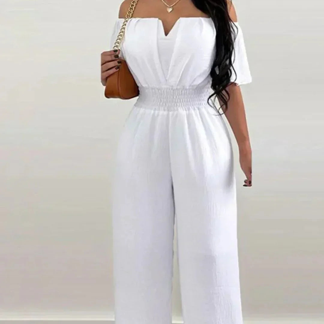 Woman enjoying a summer day, demonstrating the comfortable fit of the light green off-shoulder jumpsuit.
