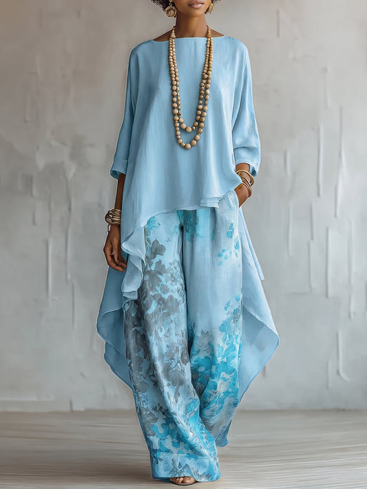 Front view of a woman wearing a light blue Aurelie flowy spring and summer dress, standing gracefully outdoors.