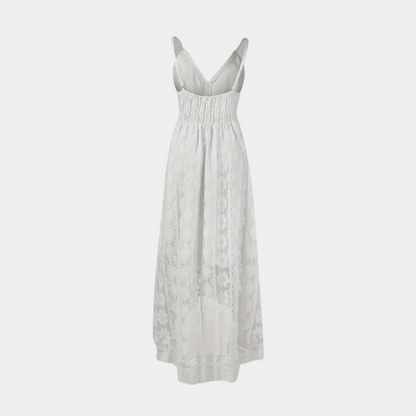 A woman twirling in the beige Bianca boho lace midi dress, emphasizing its flowy and airy design.