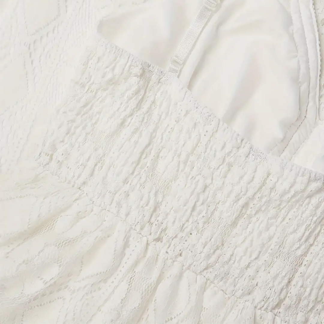 An overhead flat lay of the Bianca boho lace midi dress, displaying its intricate lace patterns and soft fabric.
