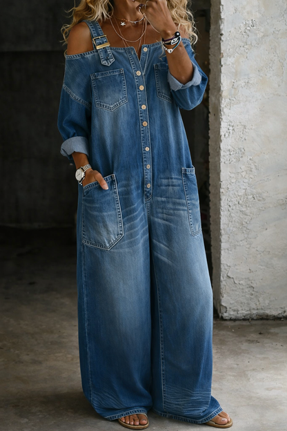 Rear view of the off-shoulder denim jumpsuit on a model, showing the full length and overall drape of the versatile garment.