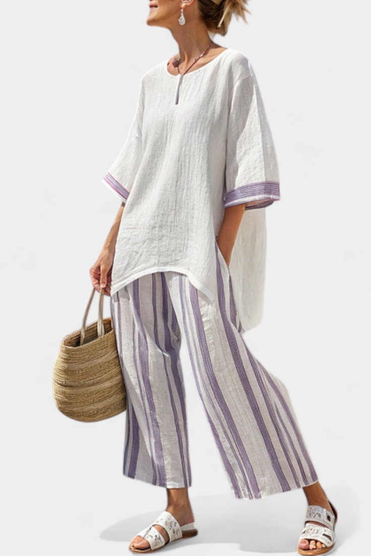 Front view of a woman wearing a purple striped relaxed blouse and matching wide-leg trousers, showcasing the full summer set.