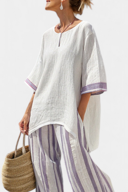 Close-up detail of the breathable fabric and vertical stripe pattern on the relaxed blouse and wide-leg pant set.
