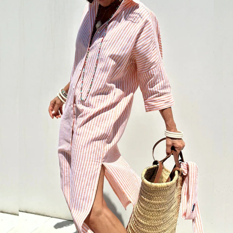Side profile of the Clara chic striped shirt dress, highlighting the flowy fabric and button detailing.