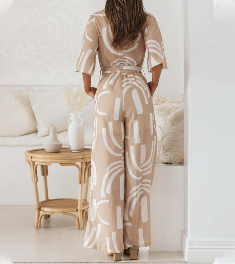 Side profile of a woman demonstrating the comfortable, relaxed fit of the patterned jumpsuit.