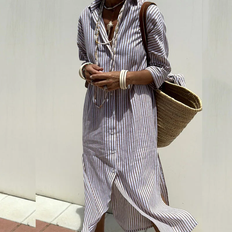 Lifestyle shot of someone wearing the Clara chic striped shirt dress, enjoying a sunny outdoor setting.