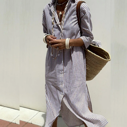 Lifestyle shot of someone wearing the Clara chic striped shirt dress, enjoying a sunny outdoor setting.