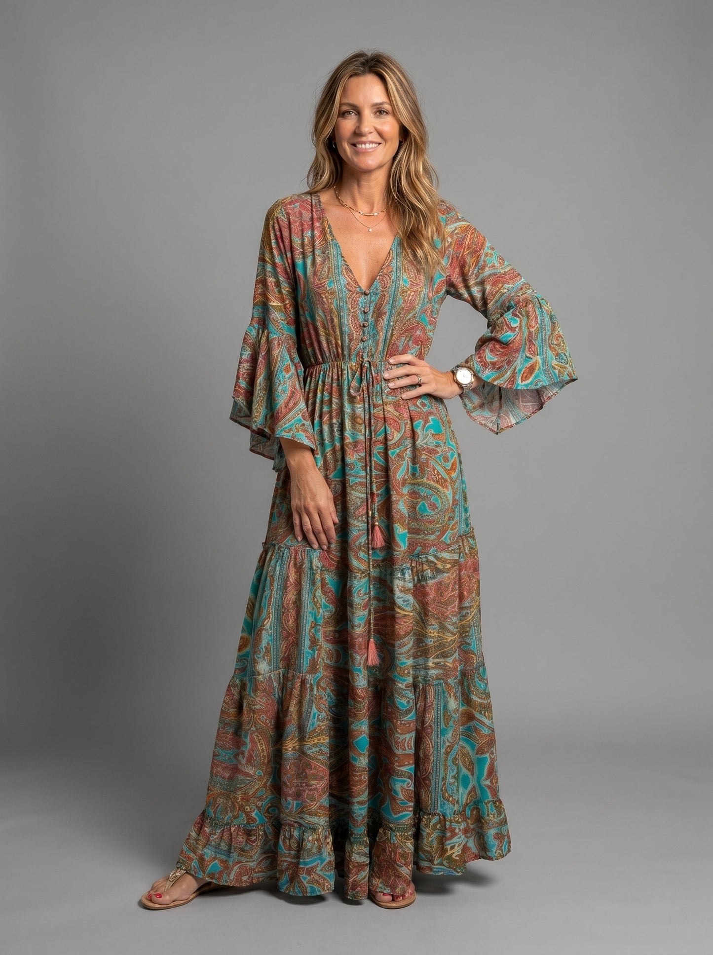 Front view of a woman wearing the blue floral maxi dress with a relaxed fit, hands in pockets.