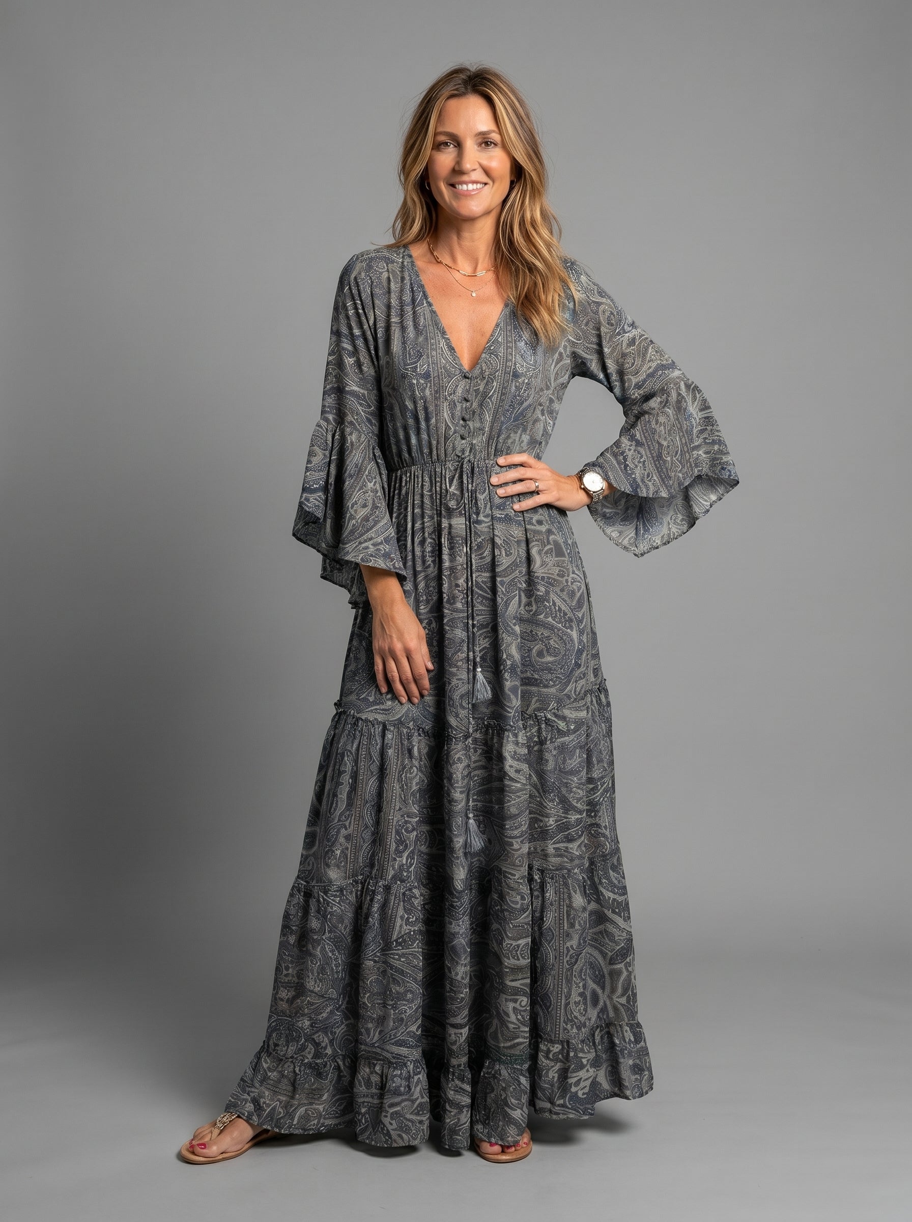 Close-up detail of the vibrant blue floral print on the lightweight chiffon maxi dress material.
