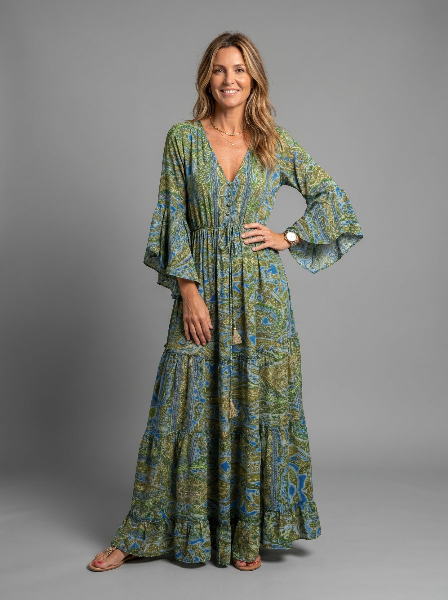 Woman sitting on a bench, showcasing the relaxed and comfortable fit of the blue floral maxi dress.