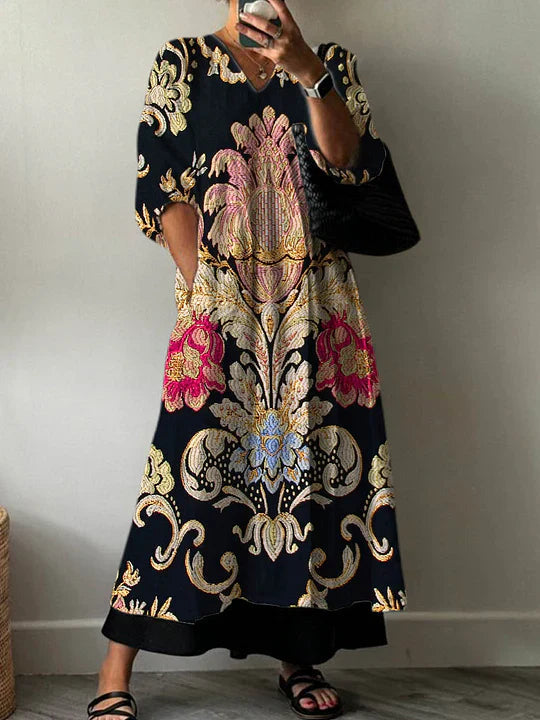 A woman wearing the Odessa patterned V-neck dress, styled casually with a confident smile, showcasing the floral design and comfortable fit.