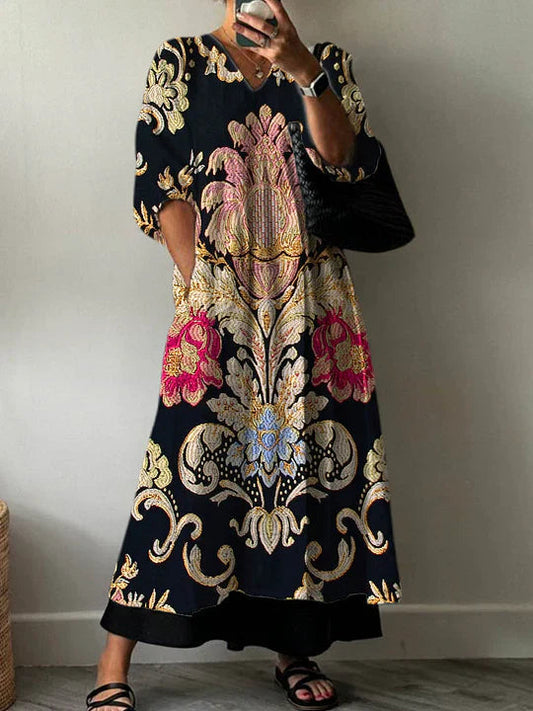 A woman wearing the Odessa patterned V-neck dress, styled casually with a confident smile, showcasing the floral design and comfortable fit.