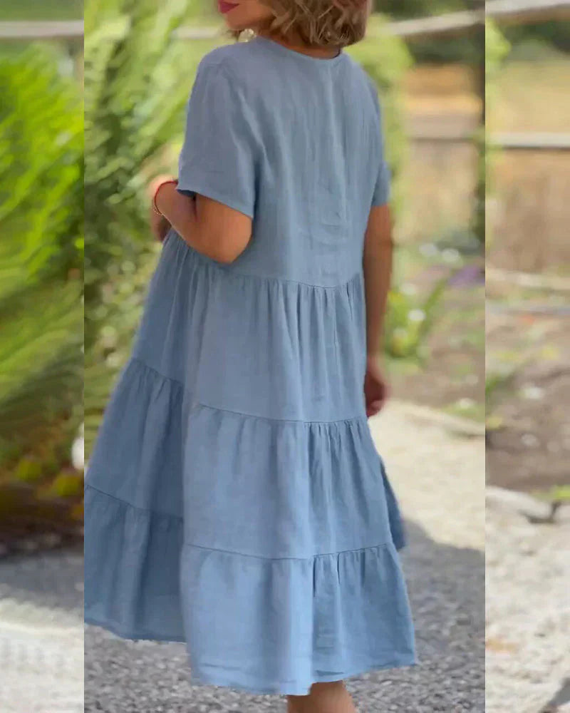 Overhead view highlighting the full, tiered skirt and the flowy silhouette of the Esmée boho midi dress in grey.