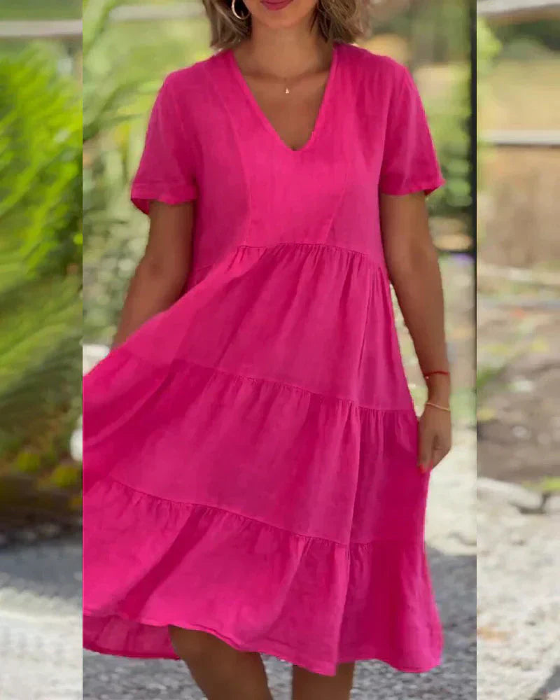Side profile of a model wearing the Esmée flowy boho midi dress in blue, highlighting the relaxed fit and short sleeves.