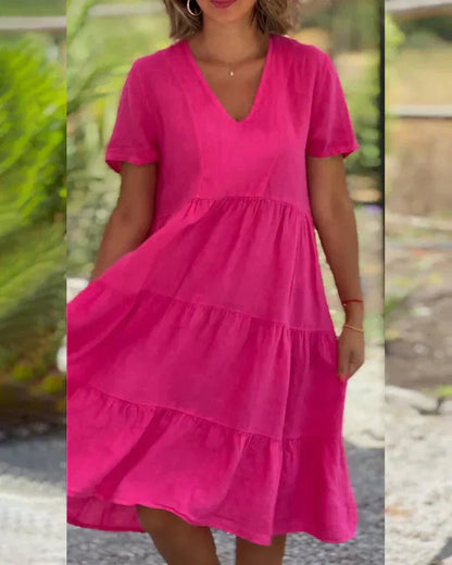 Side profile of a model wearing the Esmée flowy boho midi dress in blue, highlighting the relaxed fit and short sleeves.