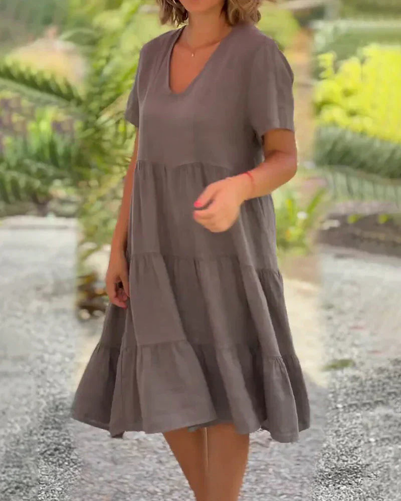 Model laughing and twirling in the Esmée flowy boho midi dress, emphasizing its comfortable movement and bohemian style.