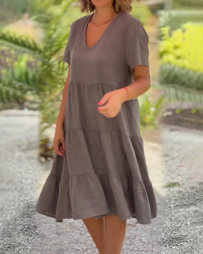 Model laughing and twirling in the Esmée flowy boho midi dress, emphasizing its comfortable movement and bohemian style.