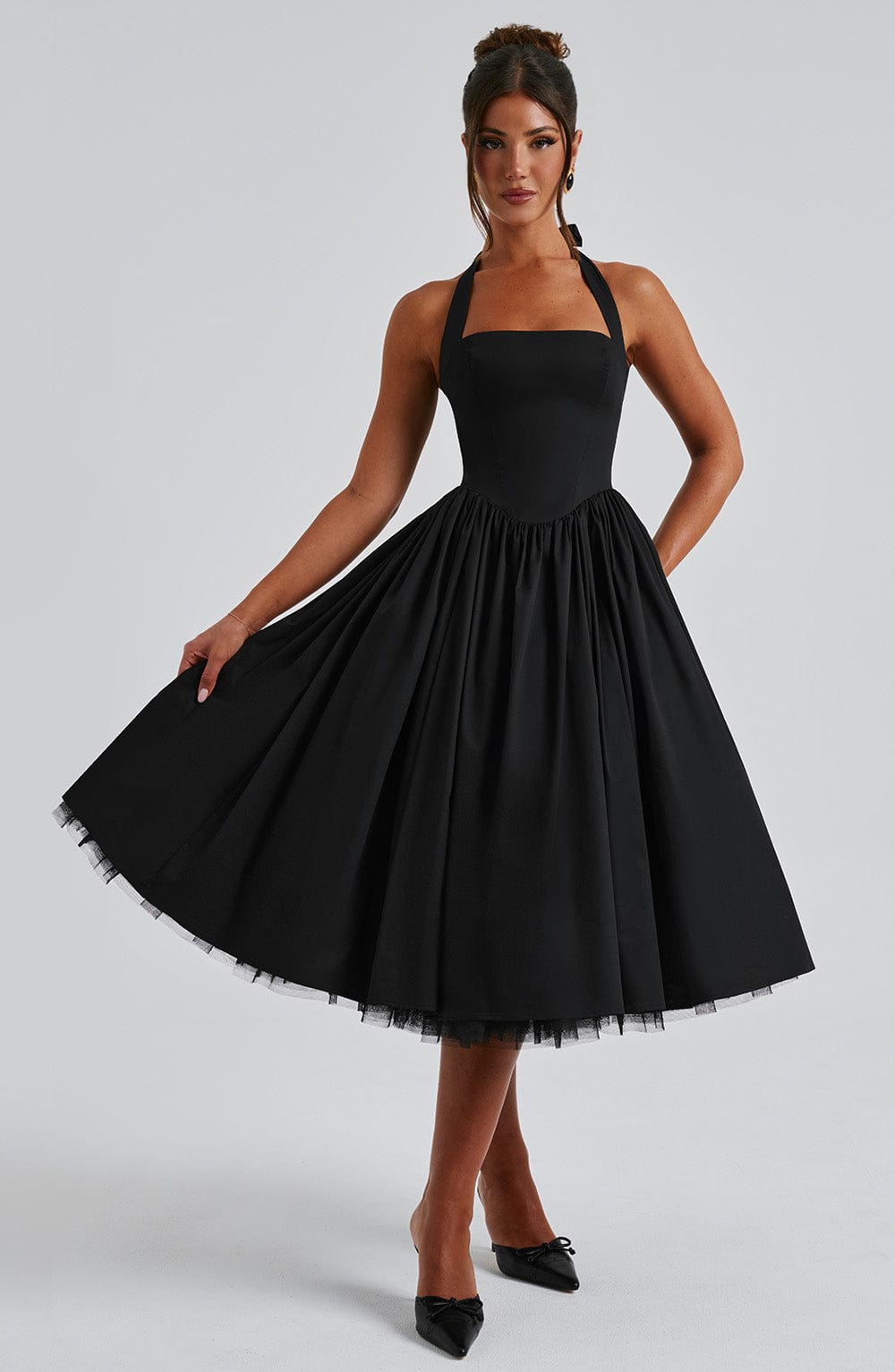 Back view of the Evanthe halter neck midi dress, highlighting the clean tie-back detail and skirt flow.