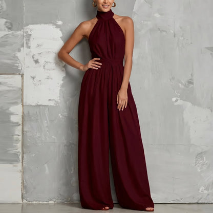 Woman walking in the Evie white wide-leg summer jumpsuit, demonstrating its comfortable movement.