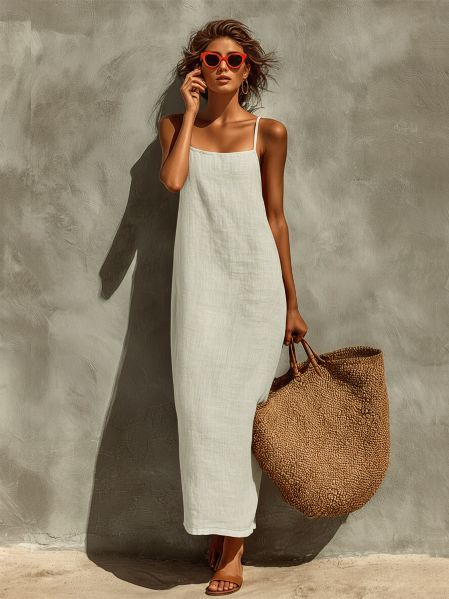 Close-up of the hemline and fabric drape of the white Evie chic summer dress, illustrating its flow.
