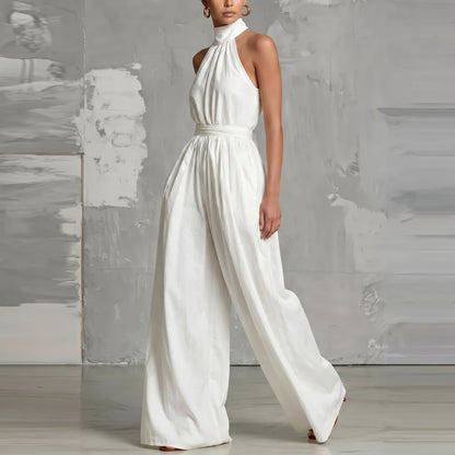 Side profile of a model wearing the Evie blue wide-leg summer jumpsuit, highlighting the flowing fabric.