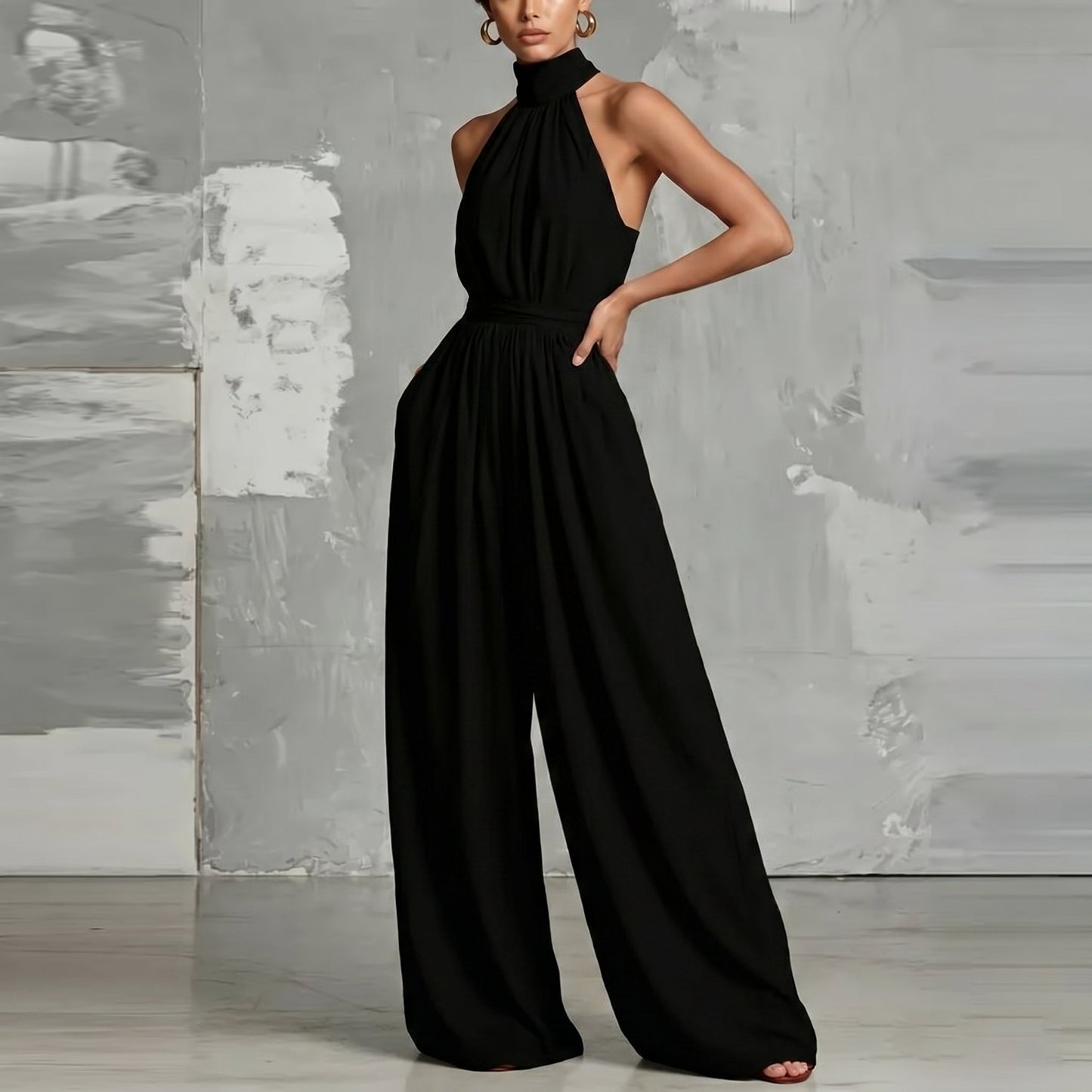 Lifestyle shot of a woman enjoying a warm day in the Evie black wide-leg summer jumpsuit, styled casually.