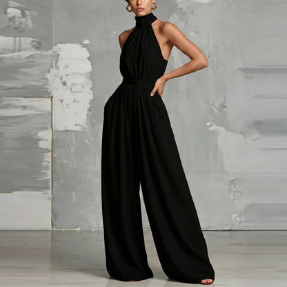 Lifestyle shot of a woman enjoying a warm day in the Evie black wide-leg summer jumpsuit, styled casually.
