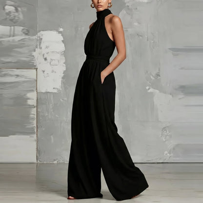 Model posing gracefully in the Evie blue wide-leg summer jumpsuit, perfect for an evening out.