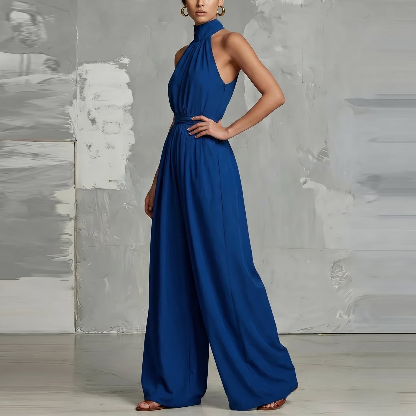 Detailed shot of the cinched waist and wide-leg cut of the Evie white summer jumpsuit.