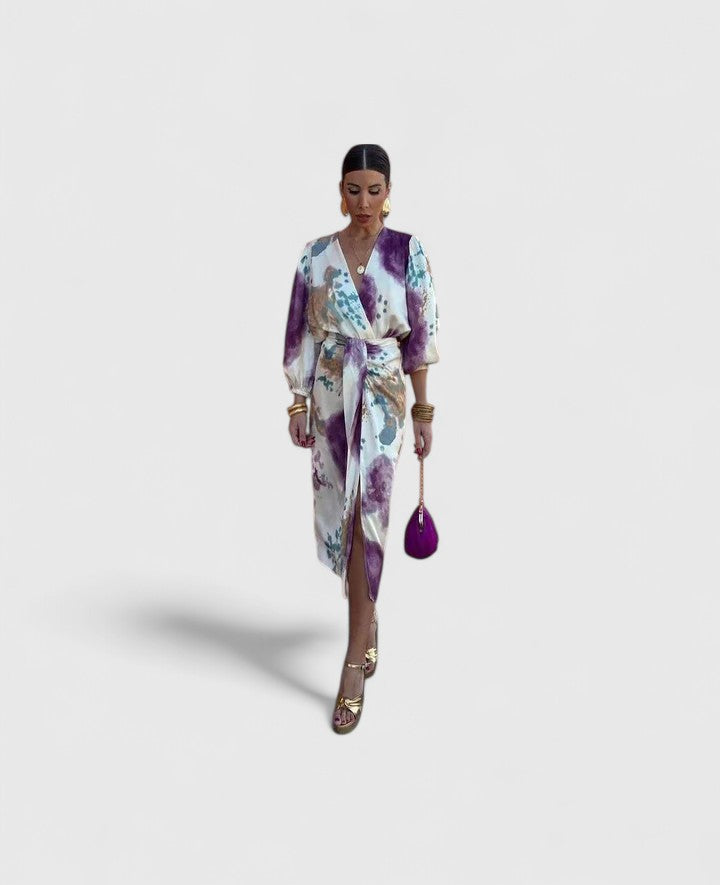 Front view of a woman wearing the Fiona chic floral midi dress, showcasing its vibrant print and flowing silhouette.
