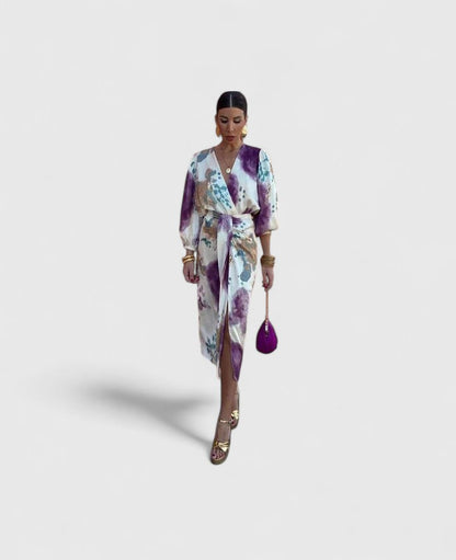 Front view of a woman wearing the Fiona chic floral midi dress, showcasing its vibrant print and flowing silhouette.