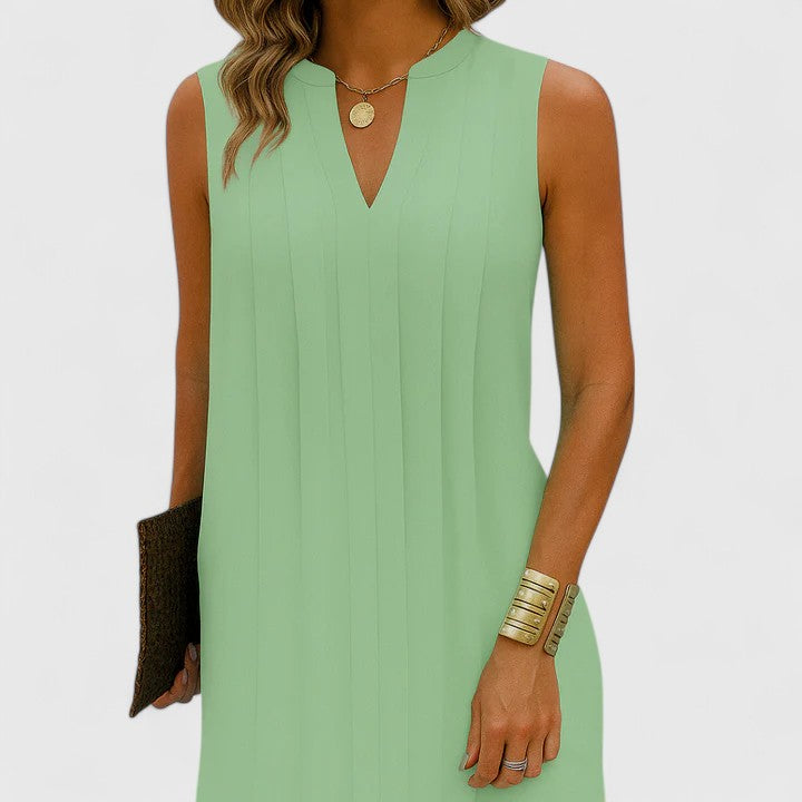 Front view of a green elegant v-neck midi dress, styled casually for a relaxed yet sophisticated daytime ensemble.