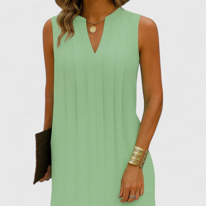 Front view of a green elegant v-neck midi dress, styled casually for a relaxed yet sophisticated daytime ensemble.