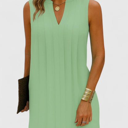 Side view of a model in the green midi dress, illustrating the flattering straight fit and length of the elegant piece.