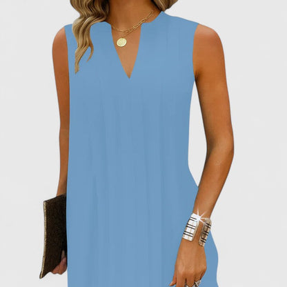Detail shot of the V-neck and shoulder area on the blue midi dress, showcasing its clean lines and refined appeal.