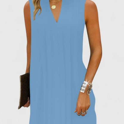 A model walking in the blue elegant v-neck midi dress, highlighting its fluid movement and ease of wear for any occasion.
